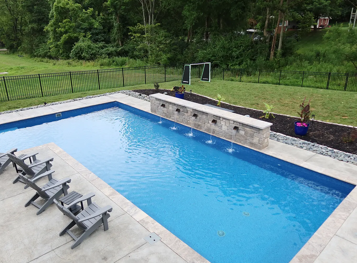 fiberglass swimming pool with added water feature in Collinsville IL
