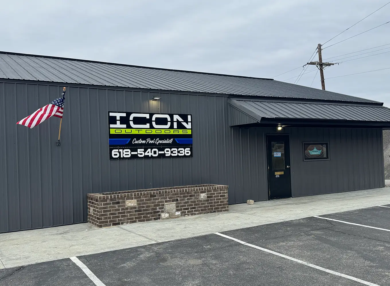 ICON Outdoors building exterior near Edwardsville IL, showcasing custom pool and outdoor living company signage.